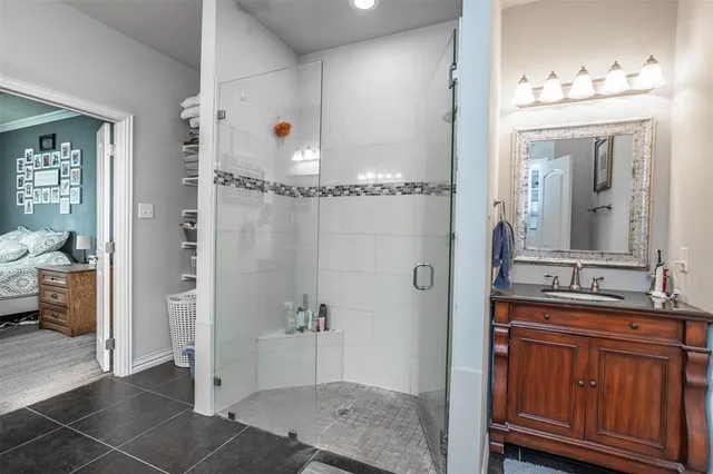 a bathroom with a granite countertop sink a mirror and a shower