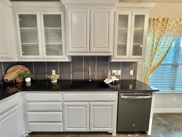 a kitchen with a sink and cabinets