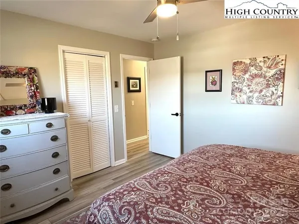 a bedroom with a bed and a dresser in it