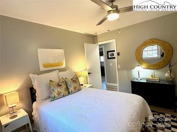 a bedroom with a bed and a chandelier