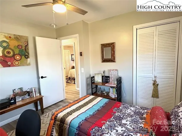 a bedroom that has a bed and a dresser in it