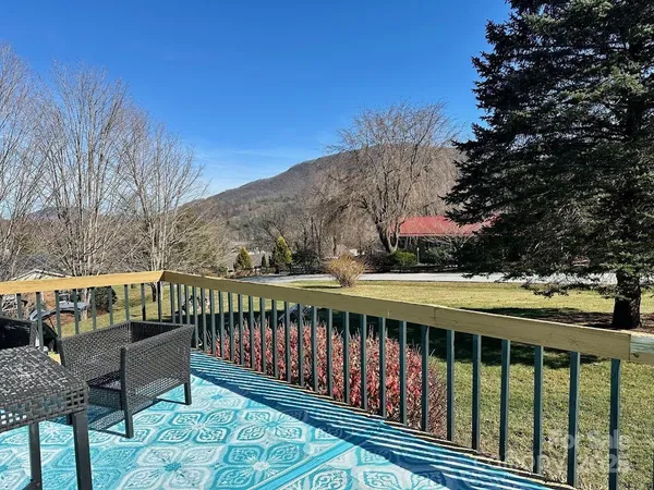 a balcony with wooden floor and fence