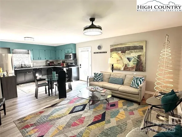 a living room with furniture and a wooden floor