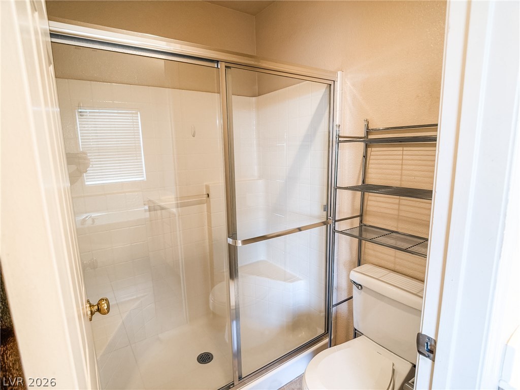 228 Positive Point Street Henderson, NV 89012 - Photo 18 of 27 A well-appointed bathroom with a spacious glass-enclosed shower.