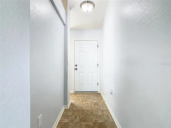 a view of a hallway with white walls