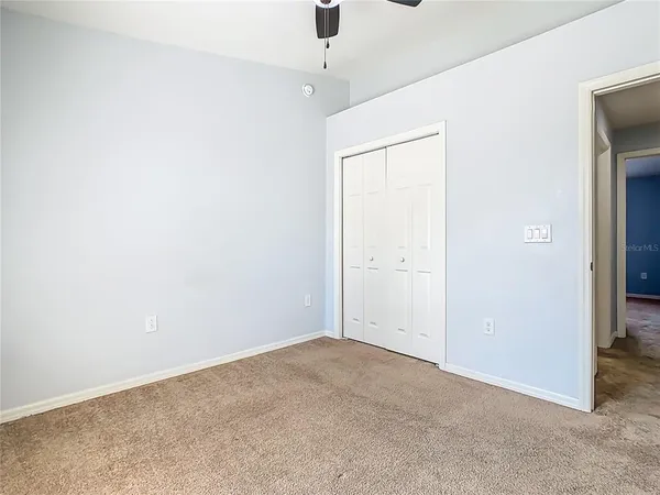 an empty room with a ceiling fan