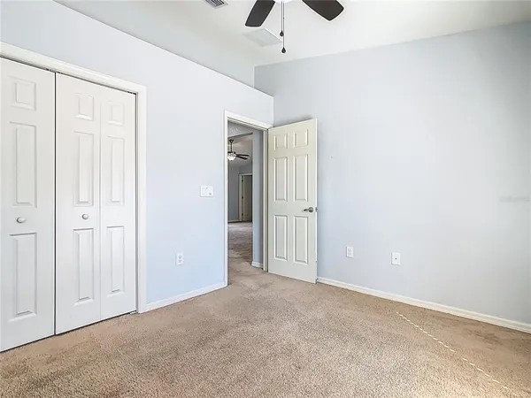 an empty room with ceiling fan