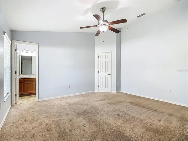 a view of a big room with closet and a ceiling fan