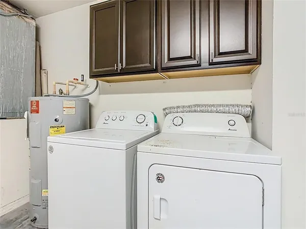 a view of a livingroom with a flat screen tv a ceiling fan and refrigerator