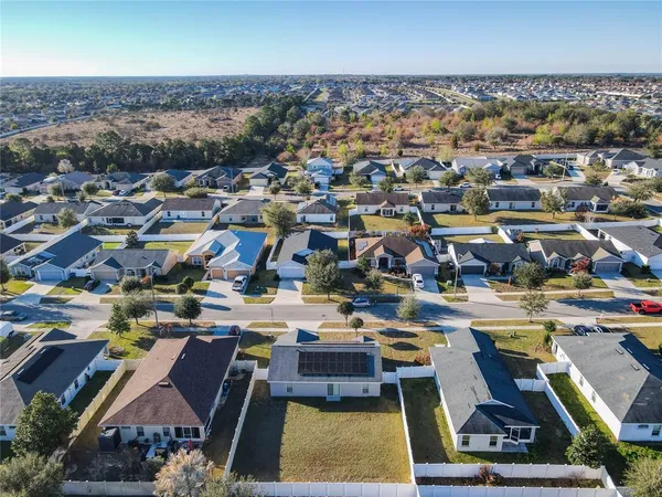 an aerial view of residential houses with city view