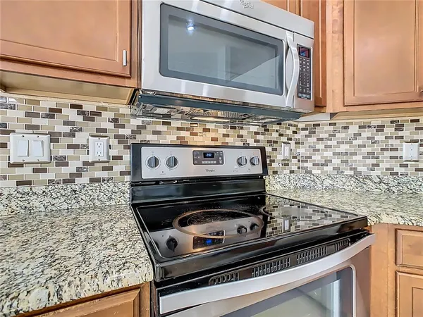 a stove top oven sitting inside of a kitchen