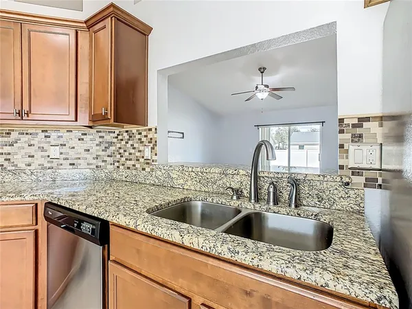a kitchen with a sink cabinets and window