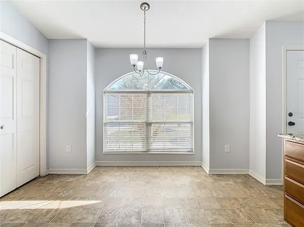 an empty room with windows and fireplace