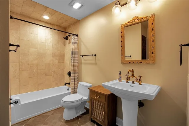 a bathroom with a toilet a sink and bathtub