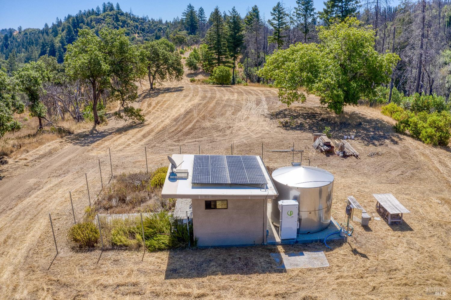 3444 Chicken Ridge Road Healdsburg, CA 95448 - Photo 1 of 12 a view of a patio with table and chairs plants and trees