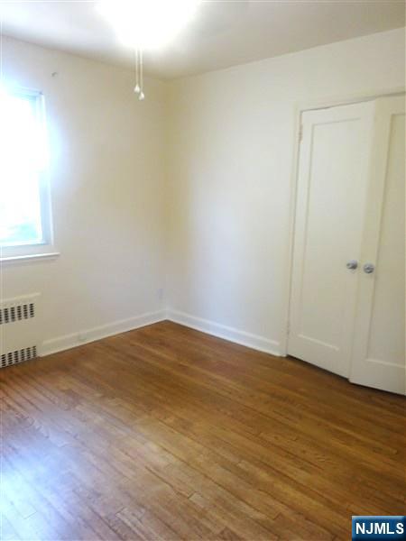 700 Kinderkamack Road River Edge, NJ 07661 - Photo 12 of 19 a view of an empty room with wooden floor and a window