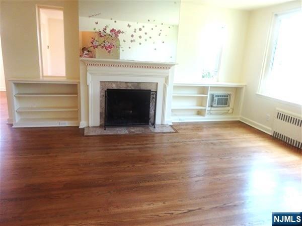 700 Kinderkamack Road River Edge, NJ 07661 - Photo 3 of 19 a view of a livingroom with wooden floor and a fireplace