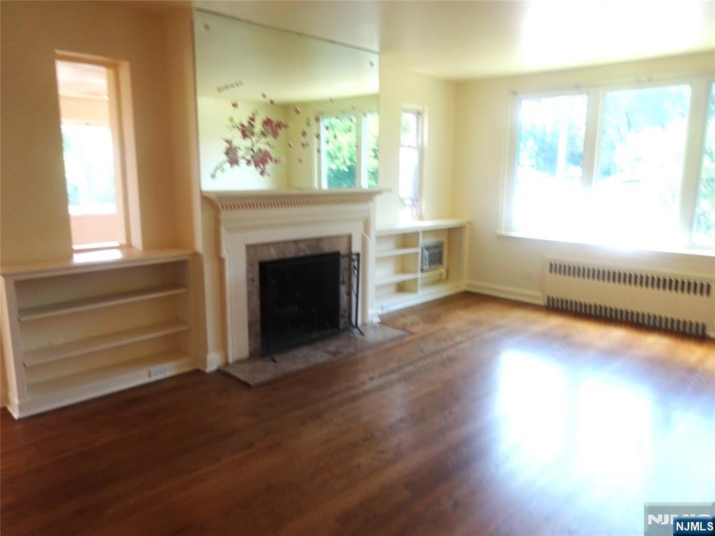 700 Kinderkamack Road River Edge, NJ 07661 - Photo 4 of 19 a view of an empty room with wooden floor and a window