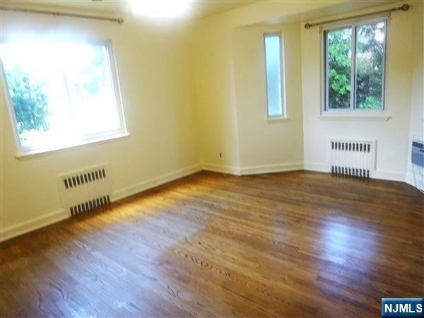 700 Kinderkamack Road River Edge, NJ 07661 - Photo 7 of 19 an empty room with wooden floor and windows