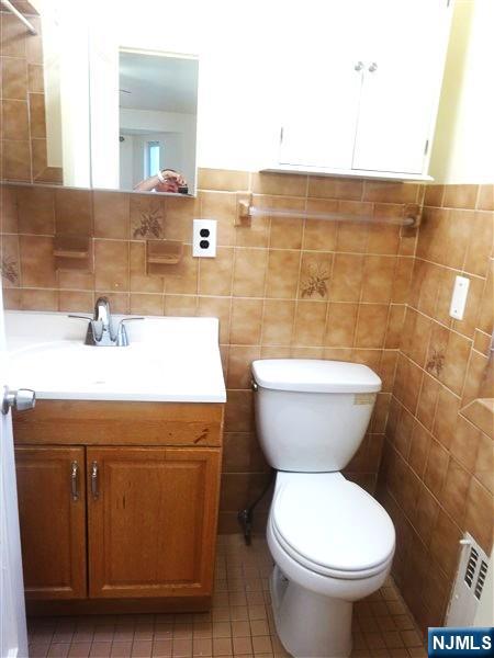 700 Kinderkamack Road River Edge, NJ 07661 - Photo 10 of 19 a bathroom with a toilet sink and mirror