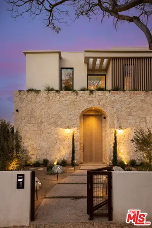 a front view of a house with parking area