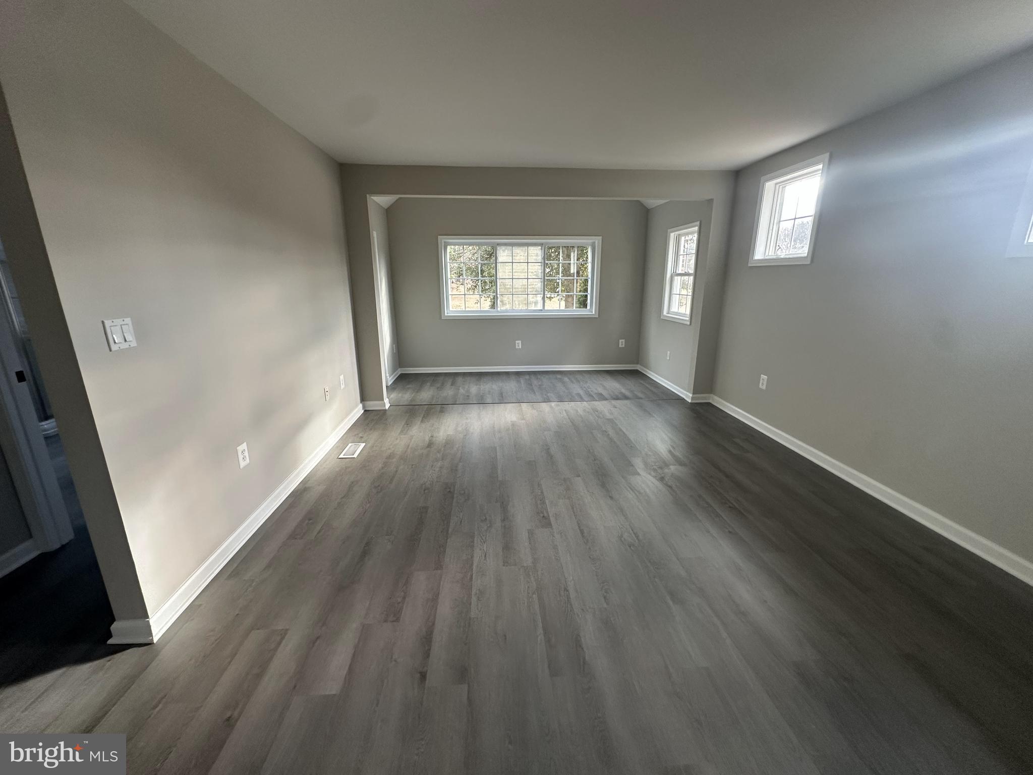 10516 Bird River Road Middle River, MD 21220 - Photo 11 of 23 an empty room with wooden floor and windows