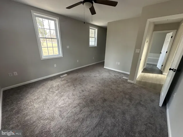 an empty room with windows and entrance
