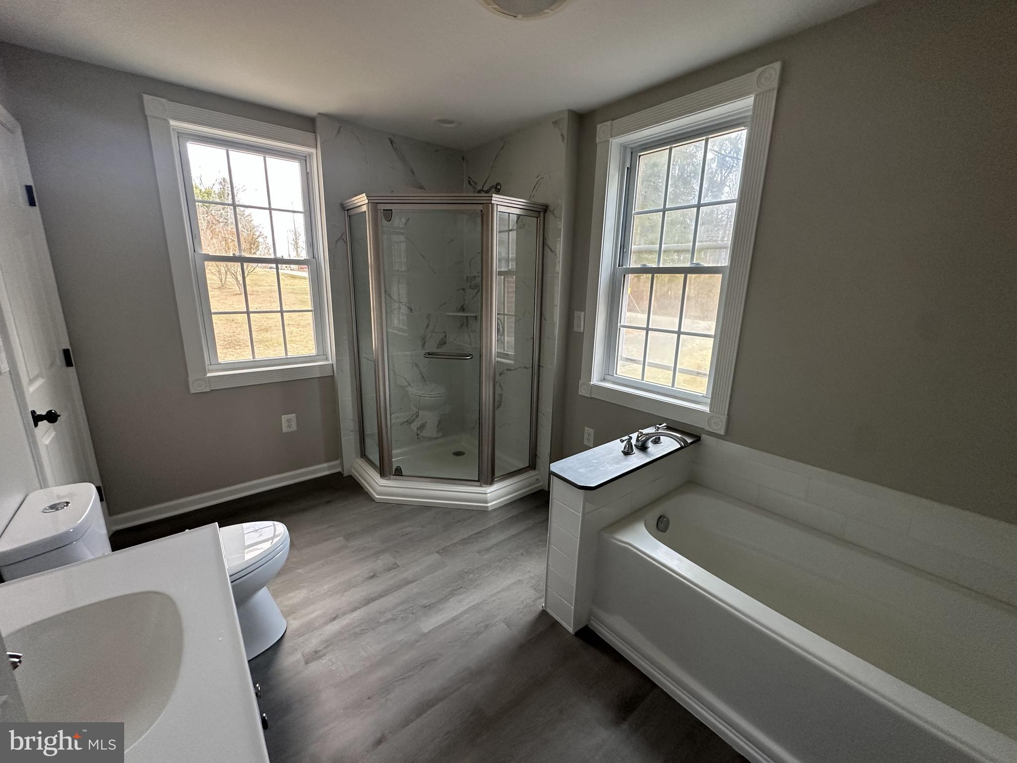 10516 Bird River Road Middle River, MD 21220 - Photo 23 of 23 a bathroom with a tub toilet and window