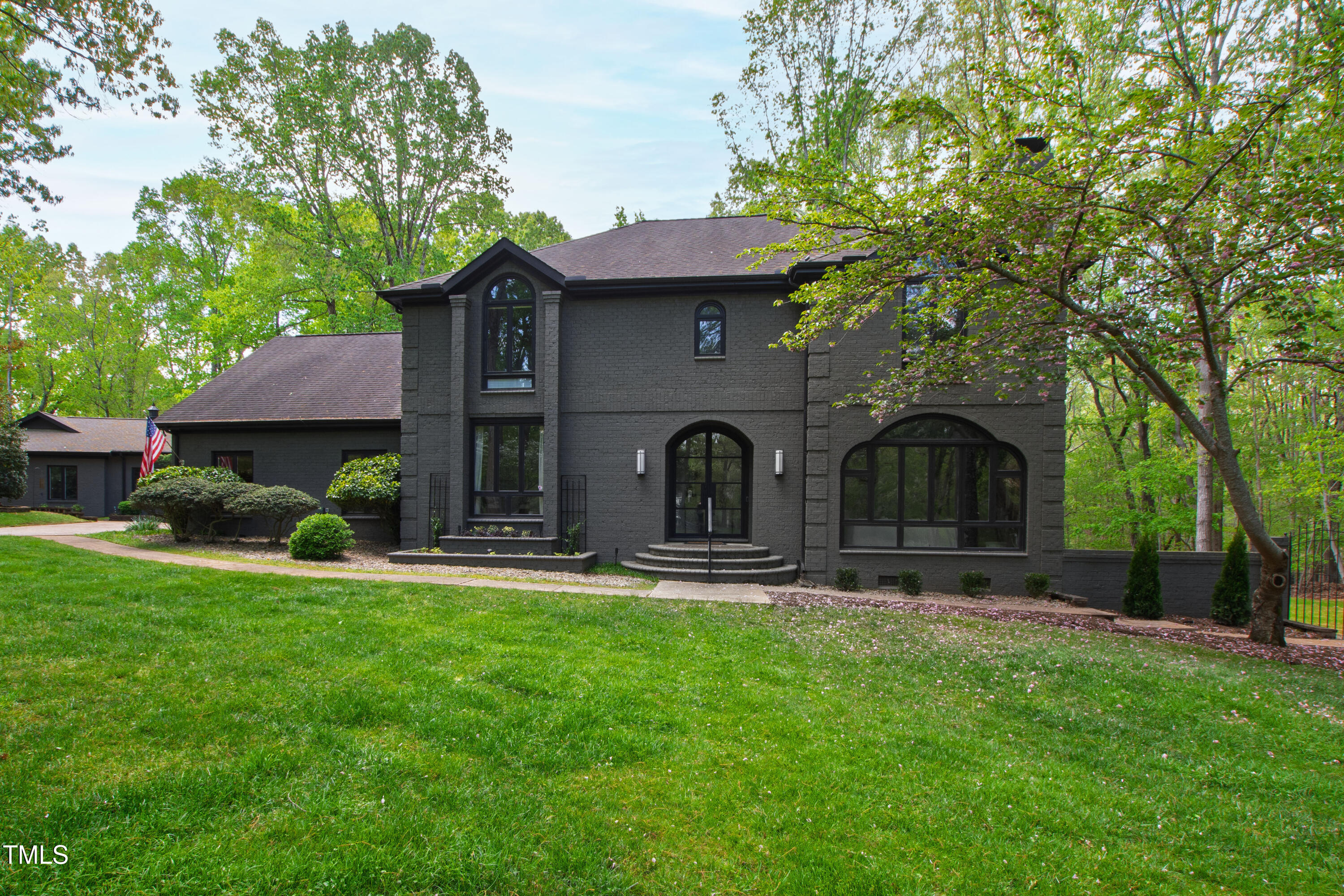 10805 The Olde Place Raleigh, NC 27614 - Photo 2 of 91 a front view of a house with garden and trees