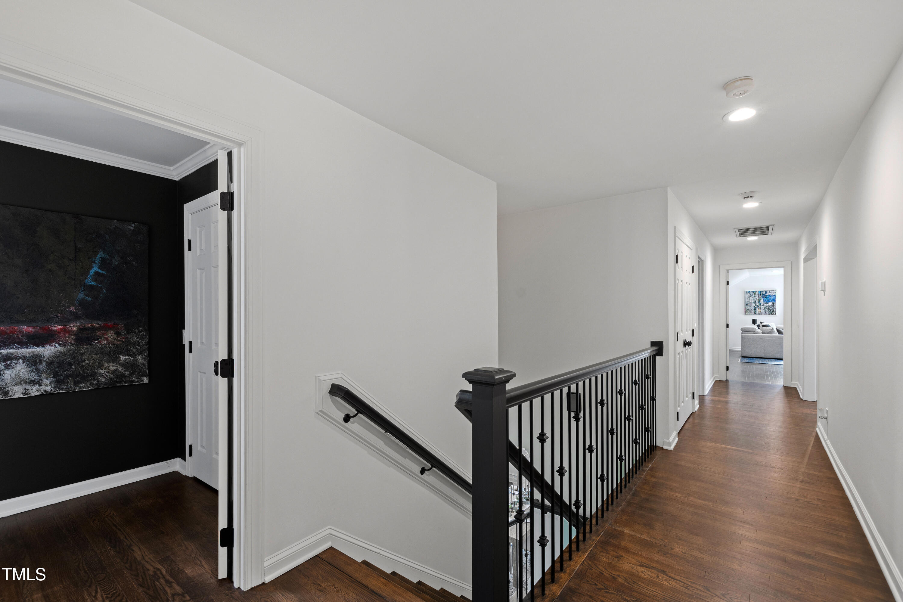 10805 The Olde Place Raleigh, NC 27614 - Photo 35 of 91 a view of a hallway with wooden floor and stairs