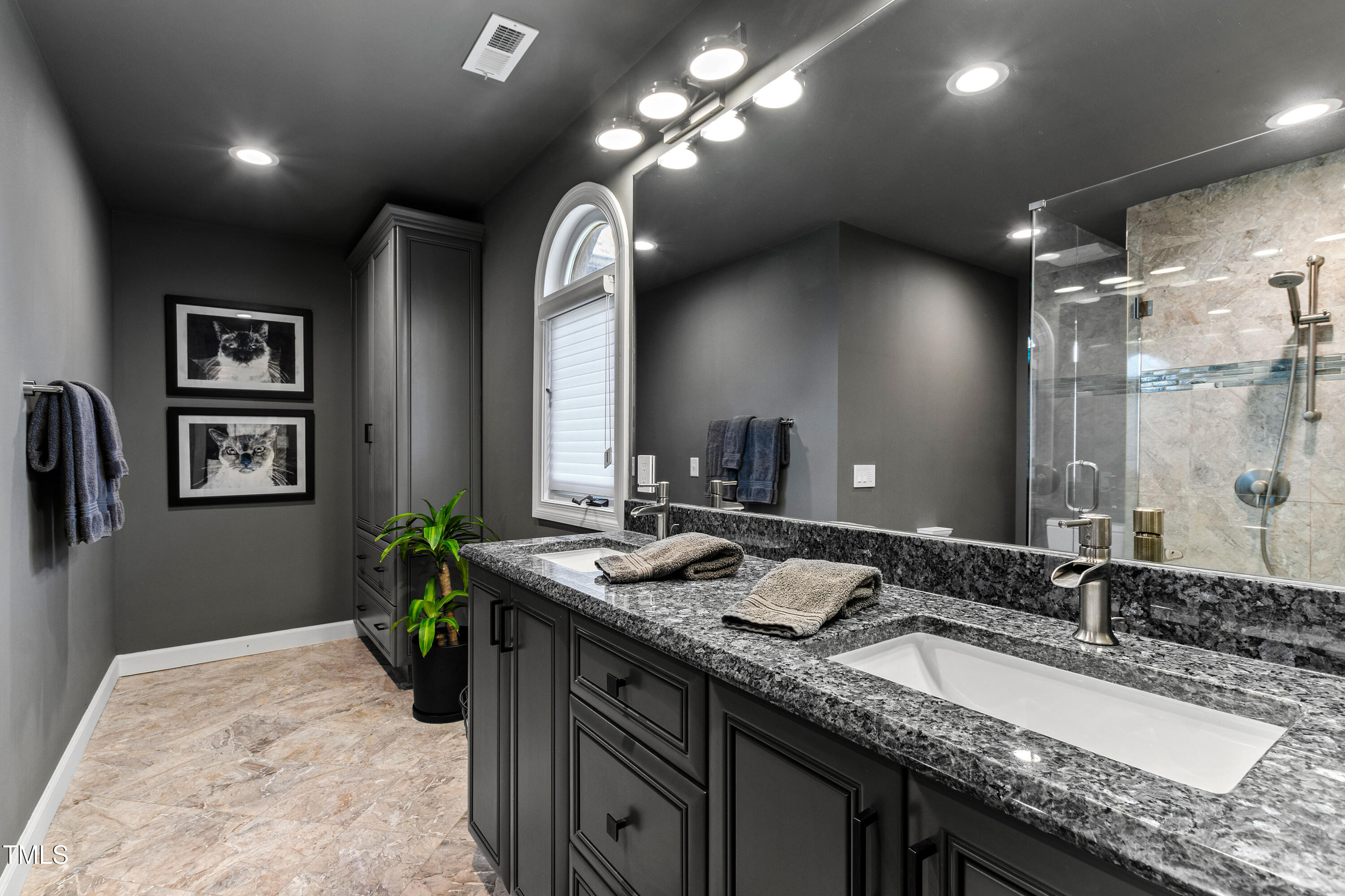 10805 The Olde Place Raleigh, NC 27614 - Photo 50 of 91 a bathroom with a granite countertop sink a large mirror and a shower