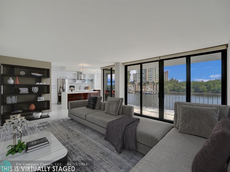 936 Intracoastal Drive, Unit 3F Fort Lauderdale, FL 33304 - Photo 1 of 43 a living room with furniture and a large window