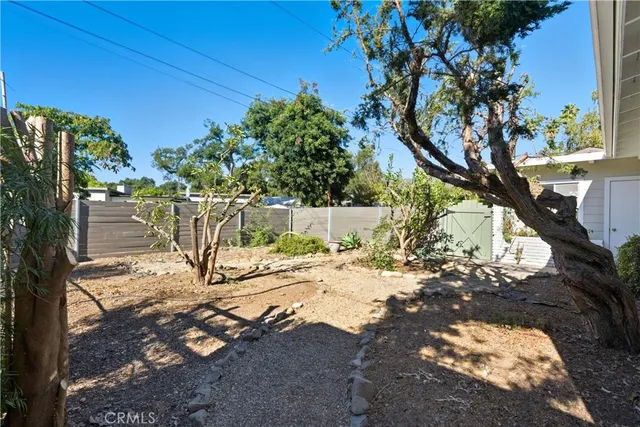a view of a yard with street tree