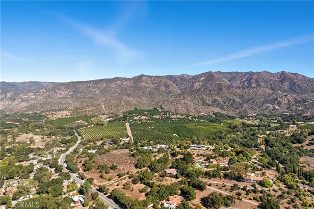 a view of a field with a mountain in the background