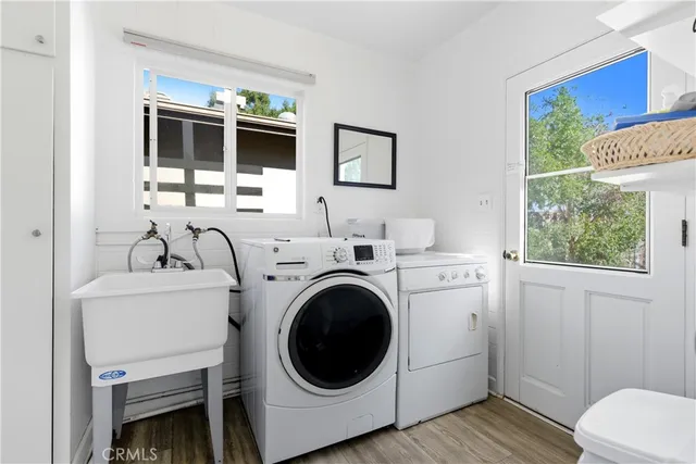 a view of a bathroom with washing machine and flat screen tv