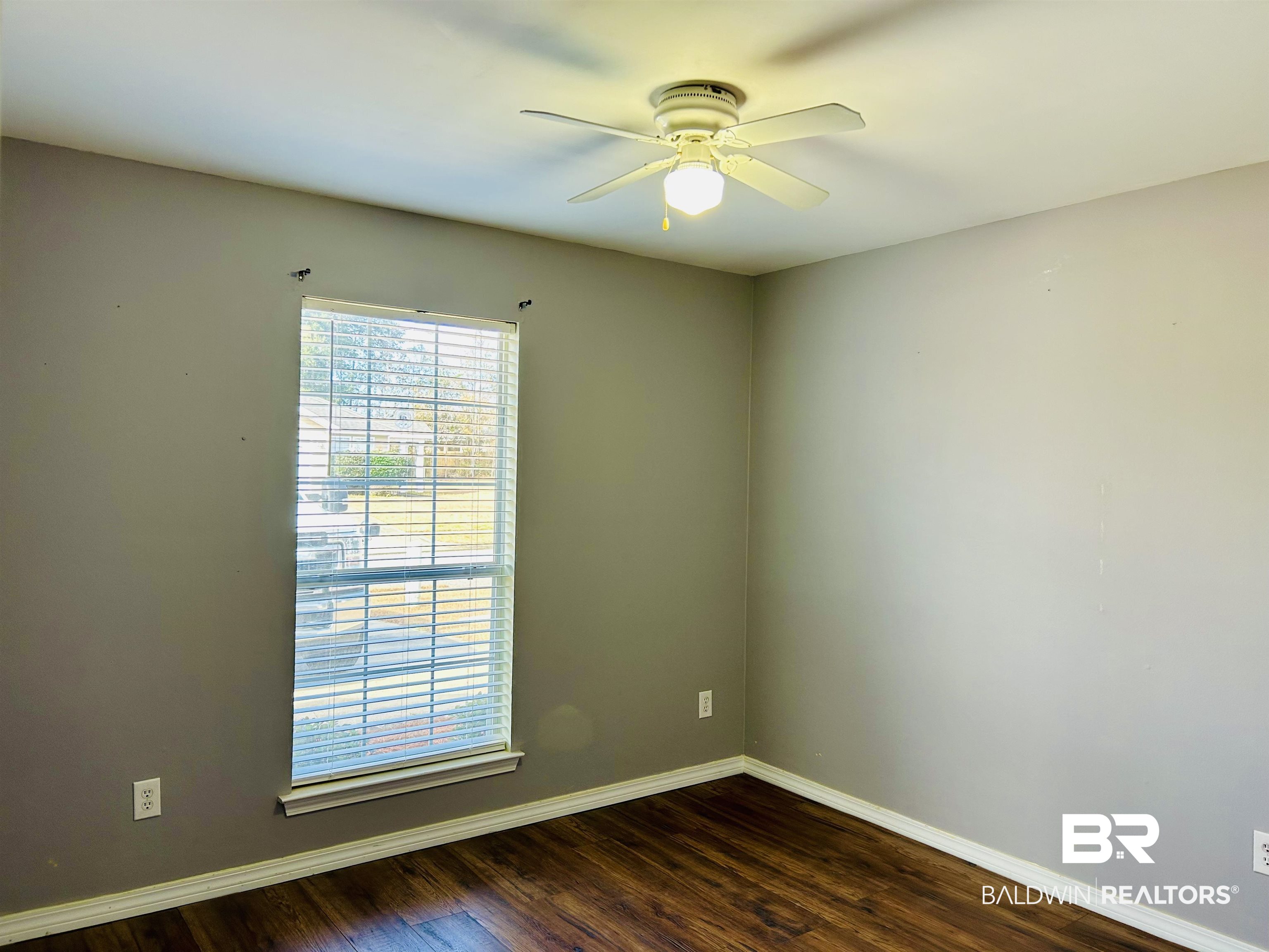 919 Parliament Court Mobile, AL 36695 - Photo 12 of 19 Spare room with ceiling fan and dark hardwood / wood-style flooring