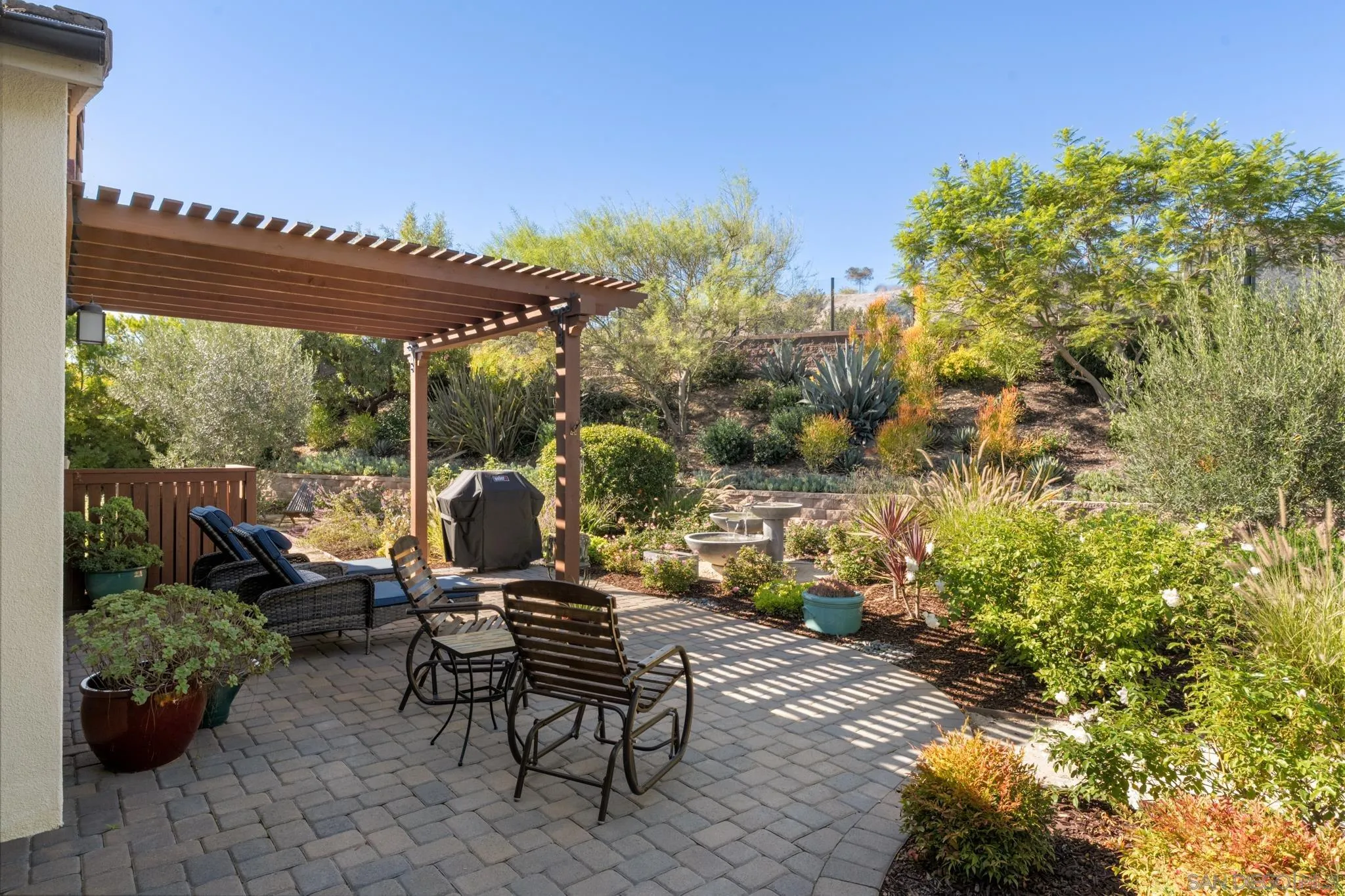 7964 Auberge Circle San Diego, CA 92127 - Photo 24 of 41 a view of a patio with table and chairs and potted plants