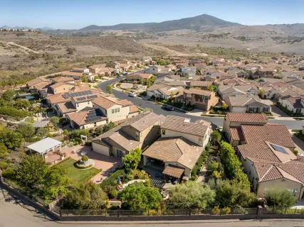 an aerial view of residential houses with outdoor space