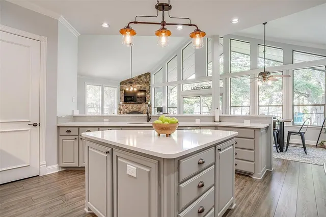 a kitchen with stainless steel appliances granite countertop a sink stove and wooden floor