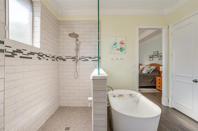 a bathroom with a bathtub a sink and a shower
