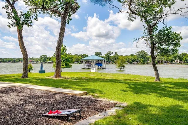 a view of a fountain in front of a house with a big yard