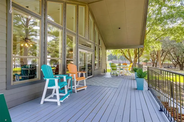 a view of a chairs and table in patio with wooden floor