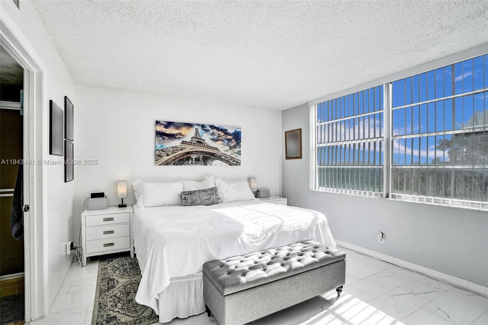 7664 Northwest 18th Street, Unit 405 Margate, FL 33063 - Photo 14 of 46 a bedroom with a bed and a window