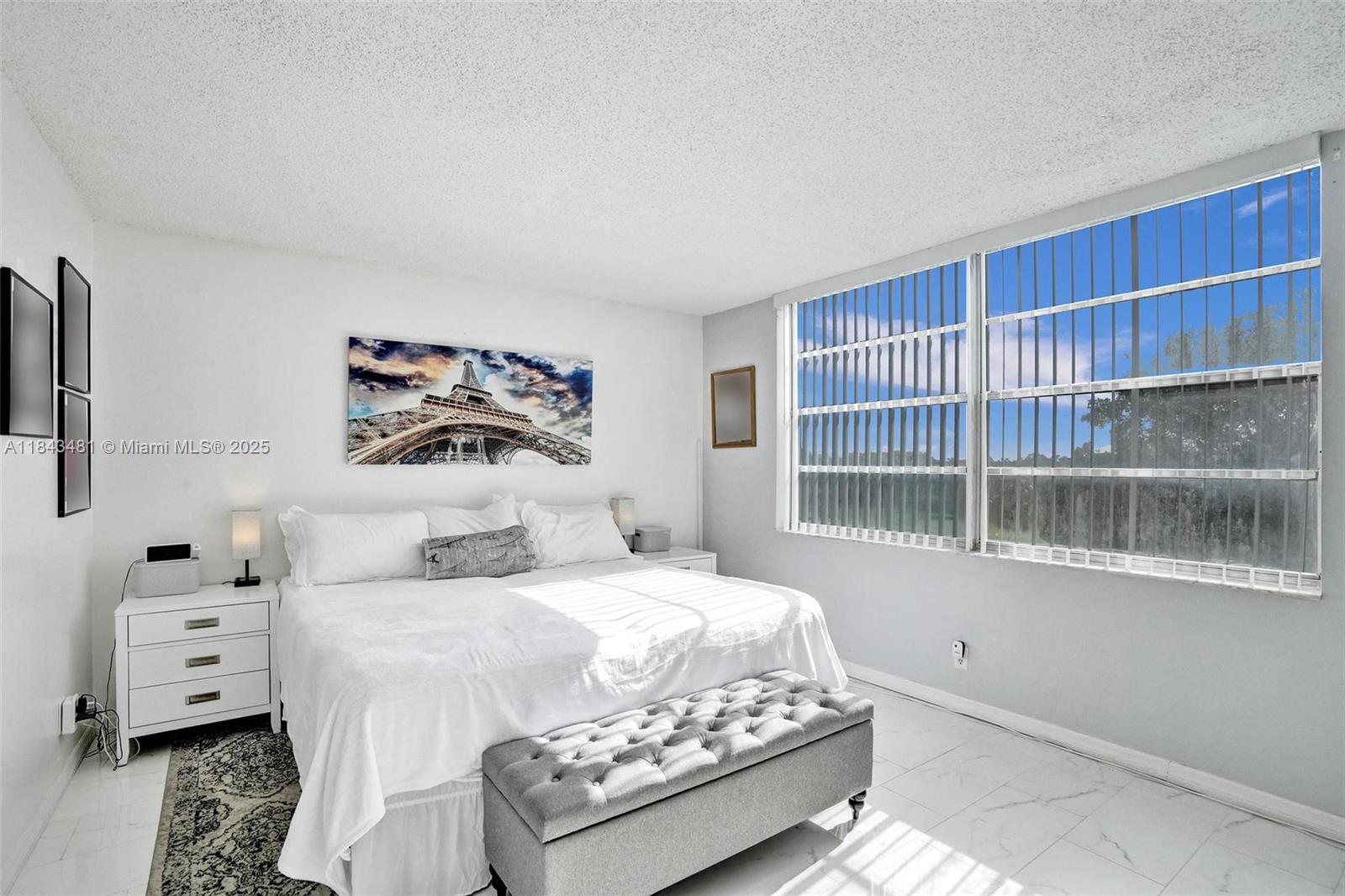 7664 Northwest 18th Street, Unit 405 Margate, FL 33063 - Photo 15 of 46 a bedroom with a bed and a large window