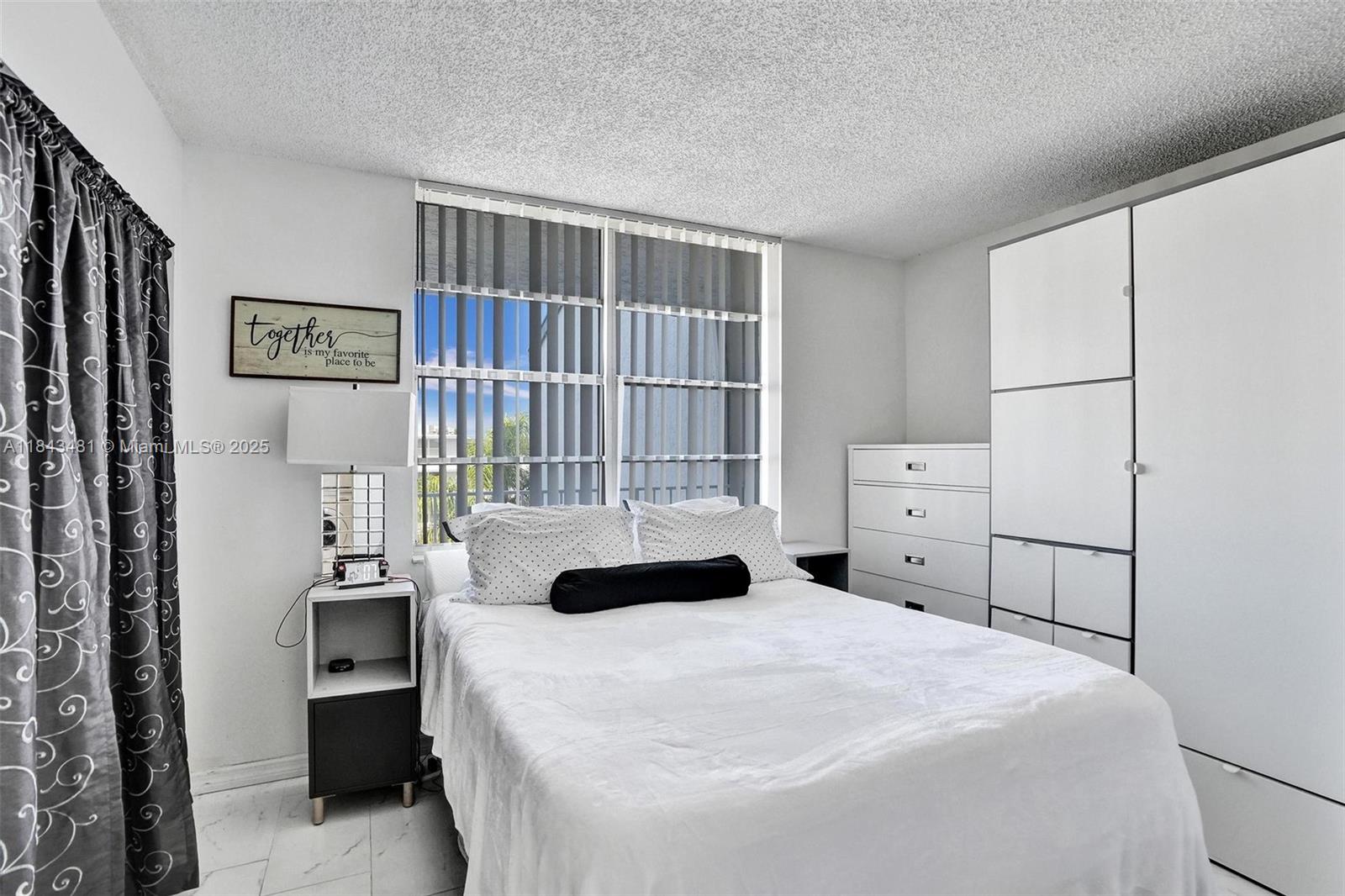 7664 Northwest 18th Street, Unit 405 Margate, FL 33063 - Photo 17 of 46 a bedroom with a bed and window