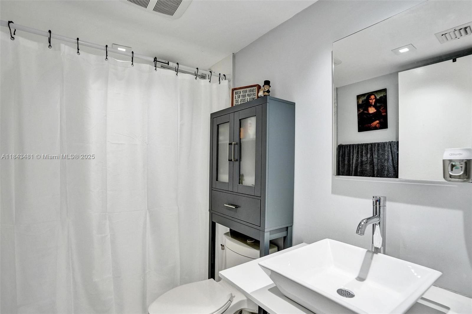 7664 Northwest 18th Street, Unit 405 Margate, FL 33063 - Photo 19 of 46 a bathroom with a sink a toilet and shower