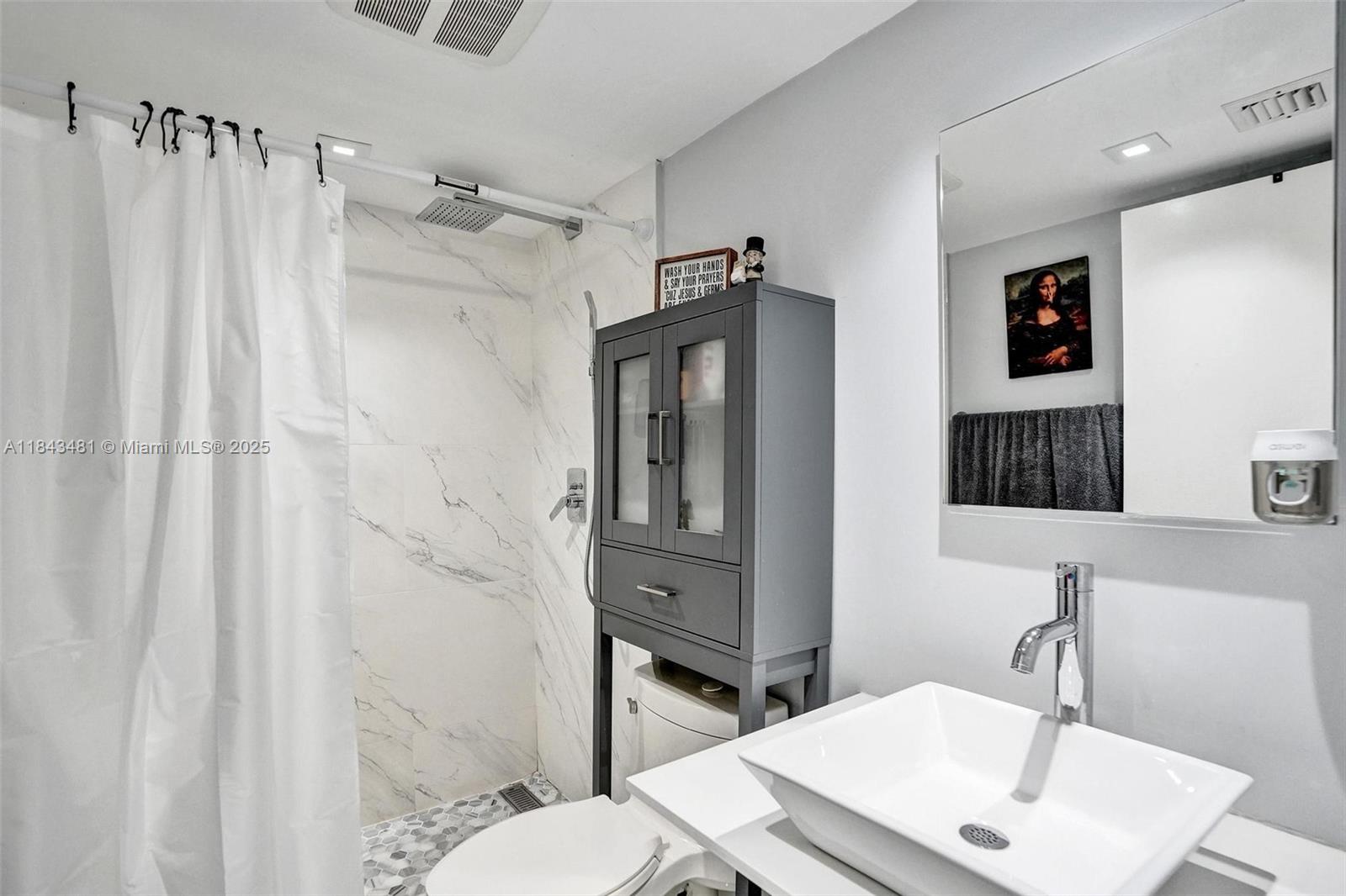 7664 Northwest 18th Street, Unit 405 Margate, FL 33063 - Photo 21 of 46 a bathroom with a sink toilet and shower