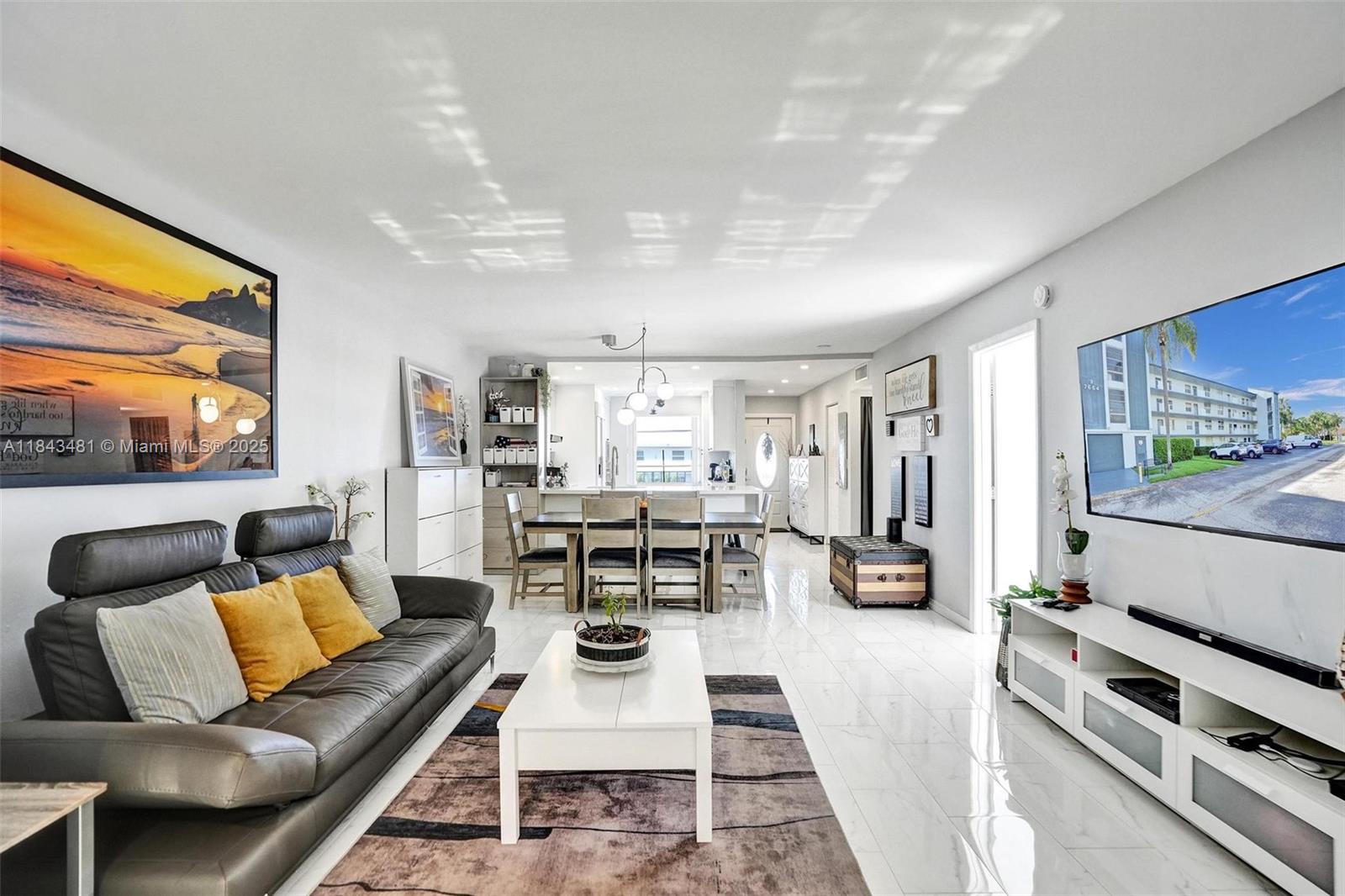 7664 Northwest 18th Street, Unit 405 Margate, FL 33063 - Photo 30 of 46 a living room with furniture and a flat screen tv