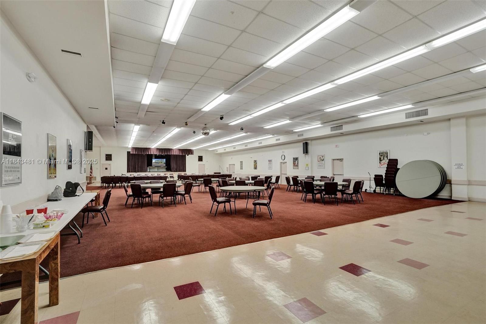 7664 Northwest 18th Street, Unit 405 Margate, FL 33063 - Photo 37 of 46 a living room with lots of furniture and white walls