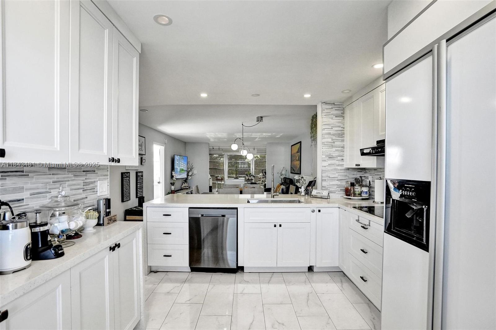 7664 Northwest 18th Street, Unit 405 Margate, FL 33063 - Photo 8 of 46 a kitchen with white cabinets and appliances